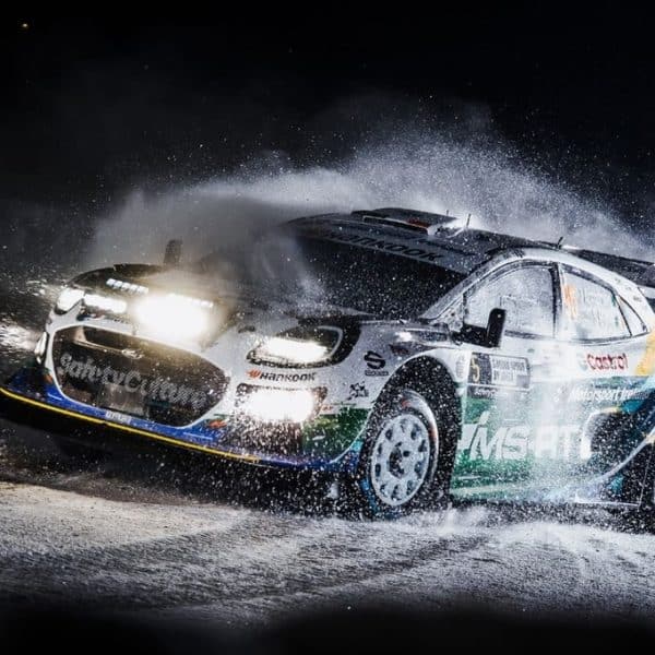 Jon Armstrong M-Sport Ford Rally Puma driving through snow during a night stage