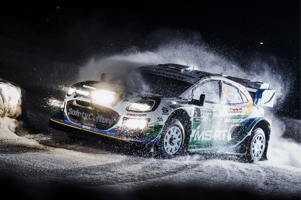 Jon Armstrong M-Sport Ford Rally Puma driving through snow during a night stage