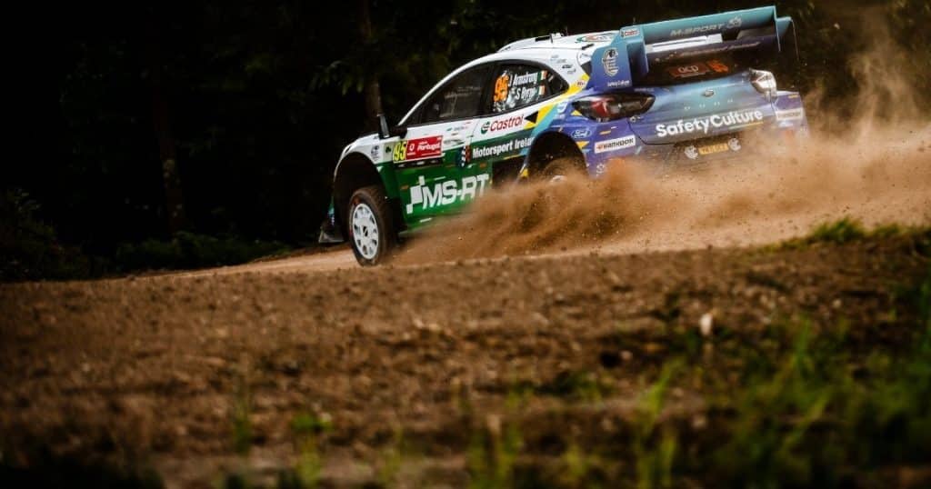 Jon Armstrong Ford Puma1 Rally car kicking up gravel on track at Rally de Portugal