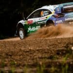 Jon Armstrong Ford Puma1 Rally car kicking up gravel on track at Rally de Portugal