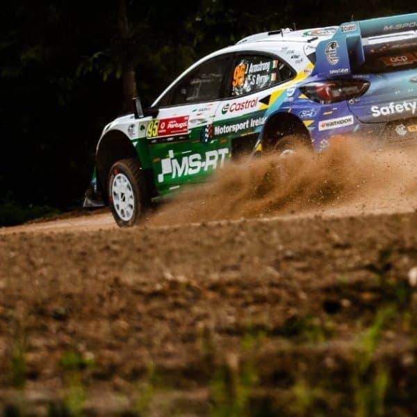 Press 2 Jon Armstrong Ford Puma1 Rally car kicking up gravel on track at Rally de Portugal