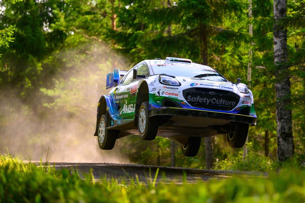 Jon Armstrong and Shane Byrne launch their M-Sport Ford Puma Rally1 over a jump on a fast forest gravel stage at Rally Finland 2026