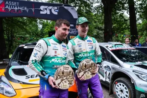 Jon Armstrong and Shane Byrne celebrate with their winners' trophies at the Grampian Forest Rally 2026