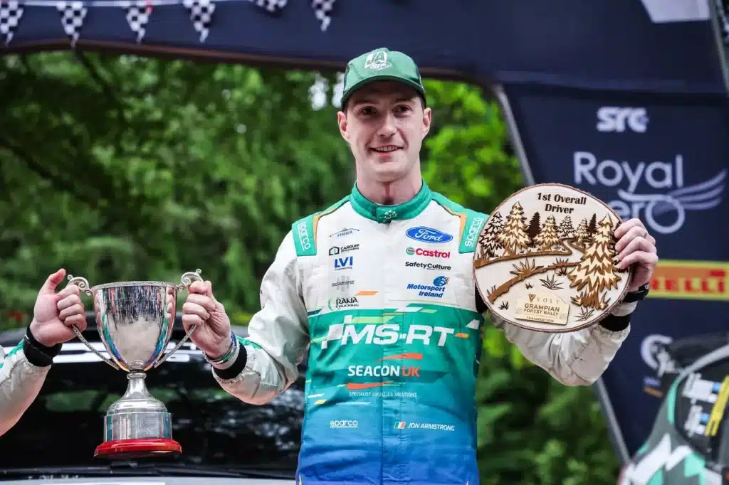 Jon Armstrong lifts the winner's cup and 1st Overall Driver trophy after victory at the Grampian Forest Rally 2026