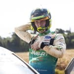 Jon Armstrong in his M-Sport Ford race suit and Motorsport Ireland Rally Academy helmet beside the Ford Puma Rally1 ahead of WRC Rally Chile 2026
