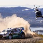 Jon Armstrong and Shane Byrne kick up a cloud of dust in their number 95 M-Sport Ford Puma Rally1 as a television helicopter tracks them above the Biobio river on a gravel stage at WRC Rally Chile 2026